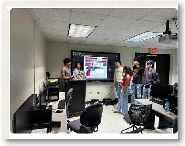 Estudiantes participan en un taller sobre cómo crear cómics usando StoryboardThat. Están reunidos en un salón de informática frente a una pantalla que muestra una historieta digital, mientras uno de ellos expone al grupo.